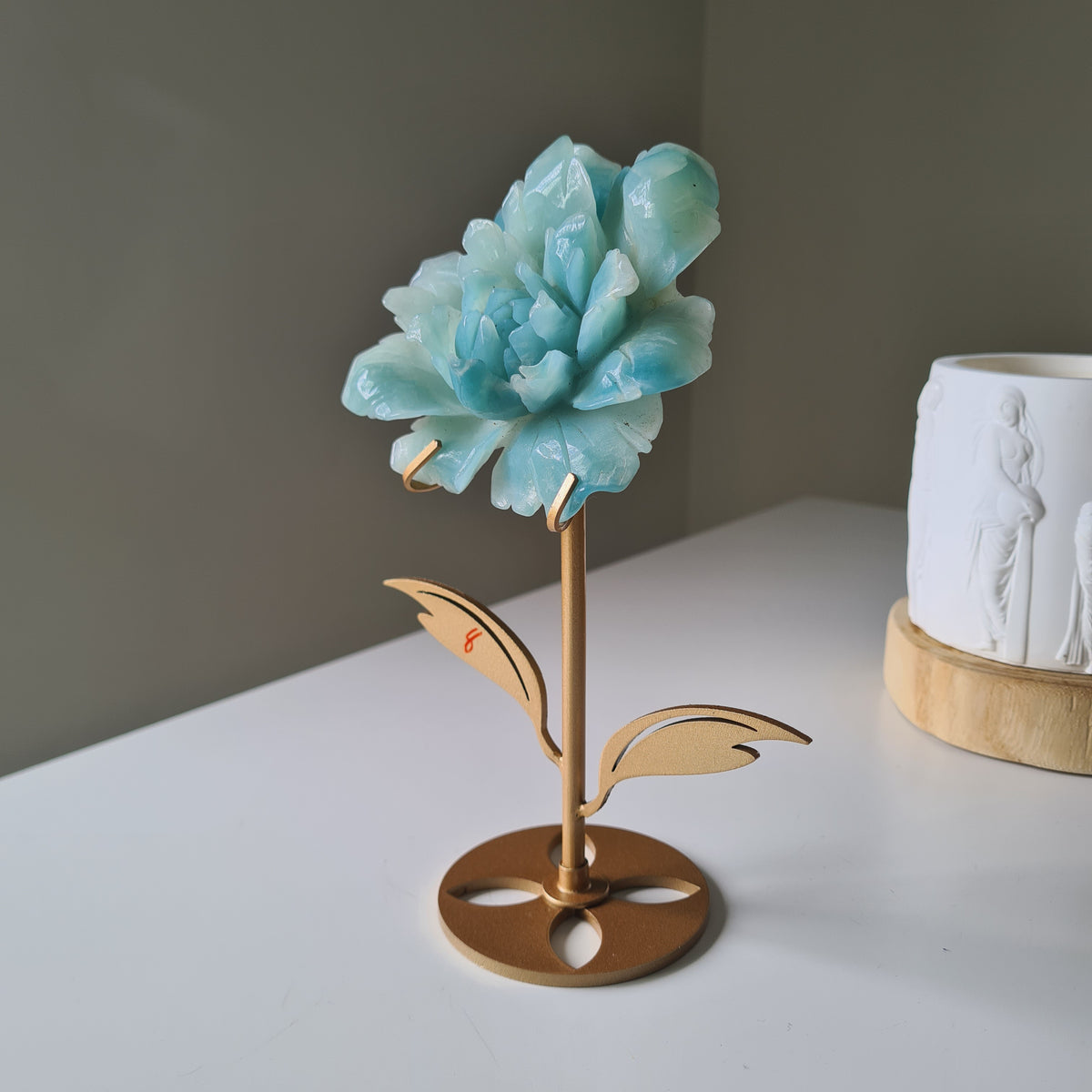 Caribbean Calcite Crystal Flower On Stand, 9 cm, with aqua petals on a gold-toned stem and leaf stand.