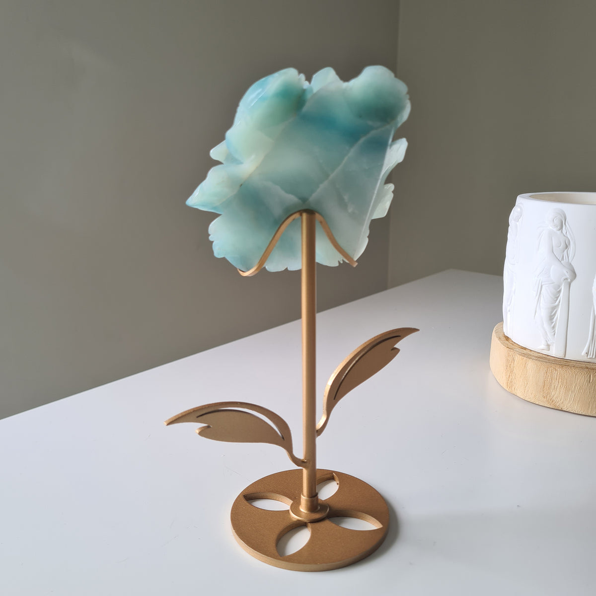Caribbean Calcite Crystal Flower On Stand, 9 cm, with aqua petals on a gold-toned stem and leaf stand.