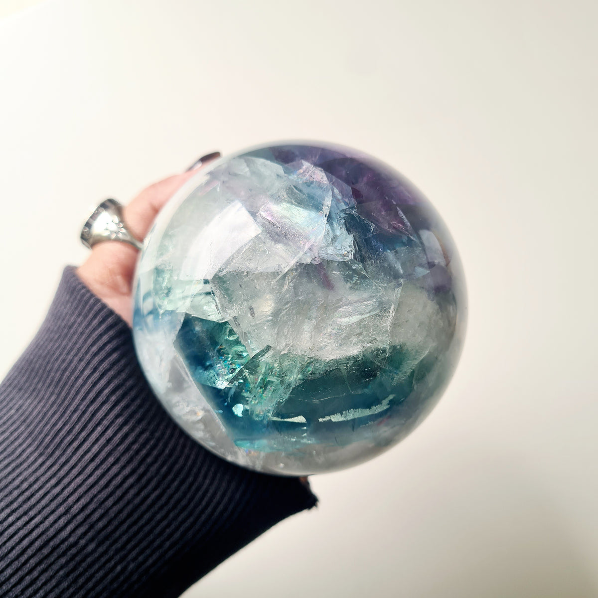 Rainbow Fluorite sphere, 8.5 cm, with green, blue and purple layers and natural internal formations.
