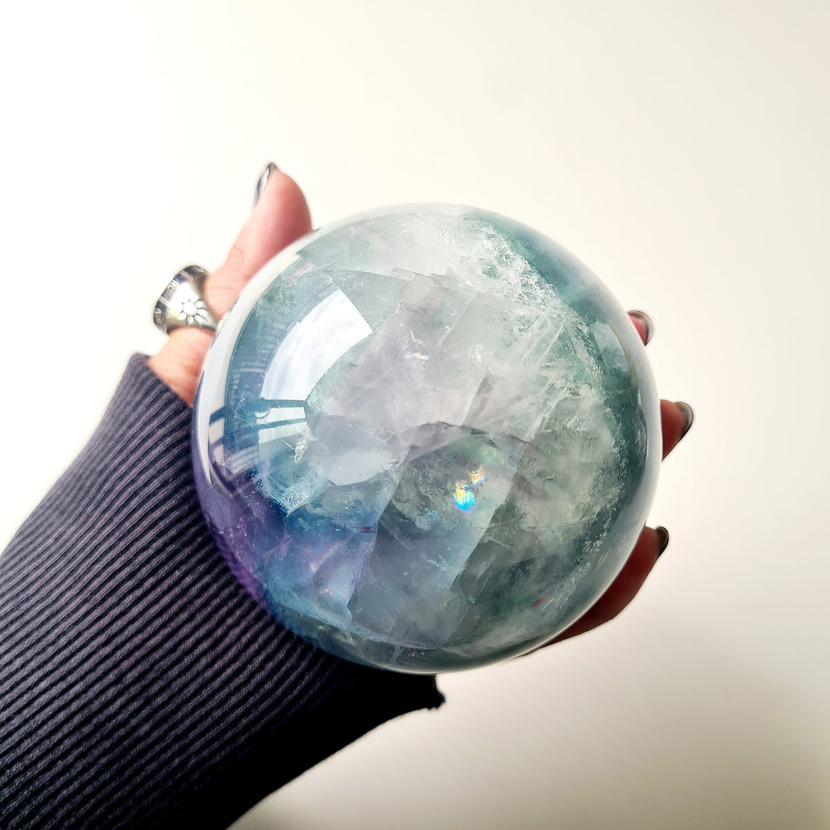 Rainbow Fluorite sphere, 8.5 cm, with green, blue and purple layers and natural internal formations.