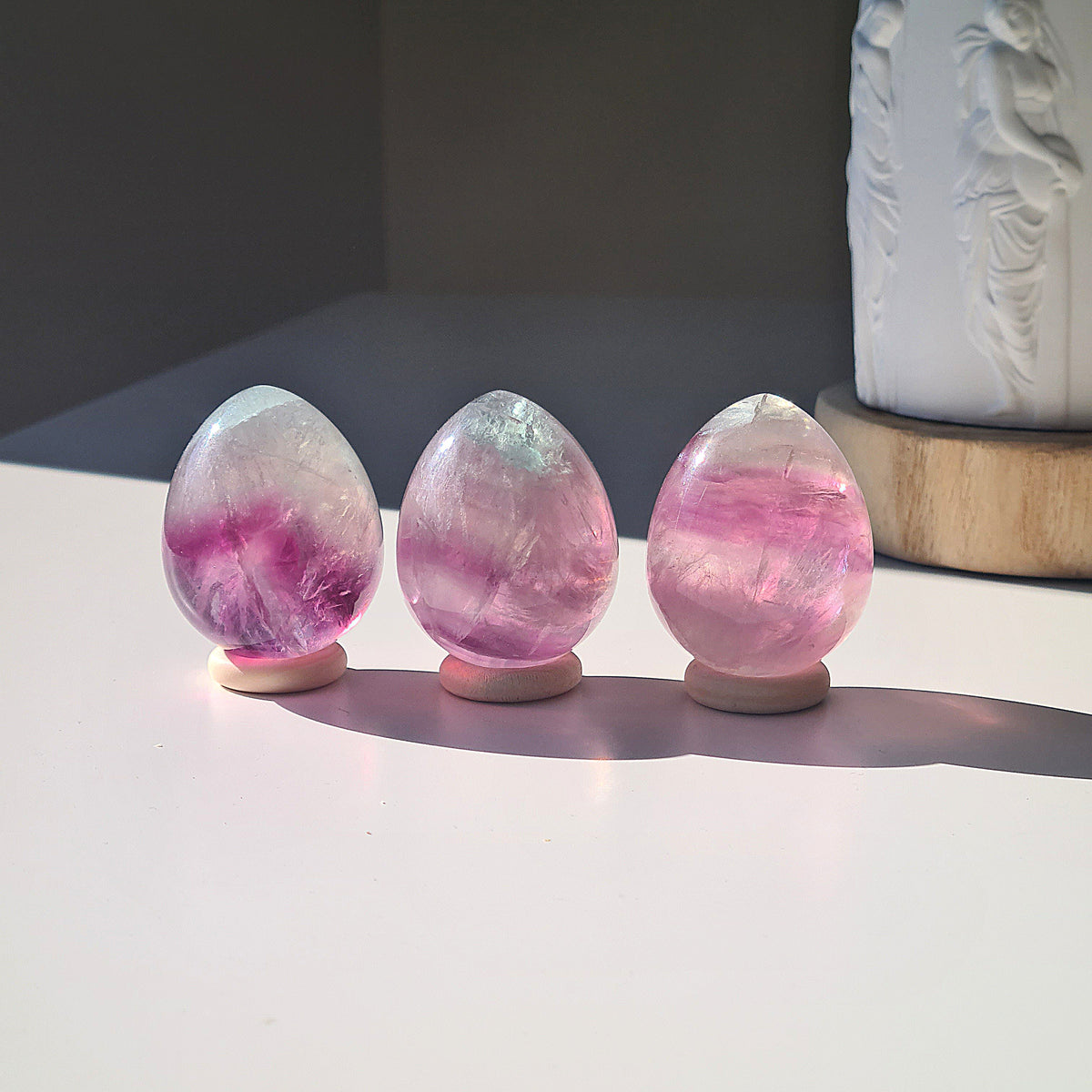 Gemmy Fluorite eggs showing their translucent purple and pink banding.