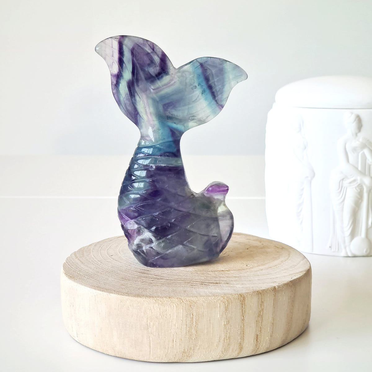 Fluorite Siren and Mermaid Tail 5 with purple, blue and green bands on a round wooden base.