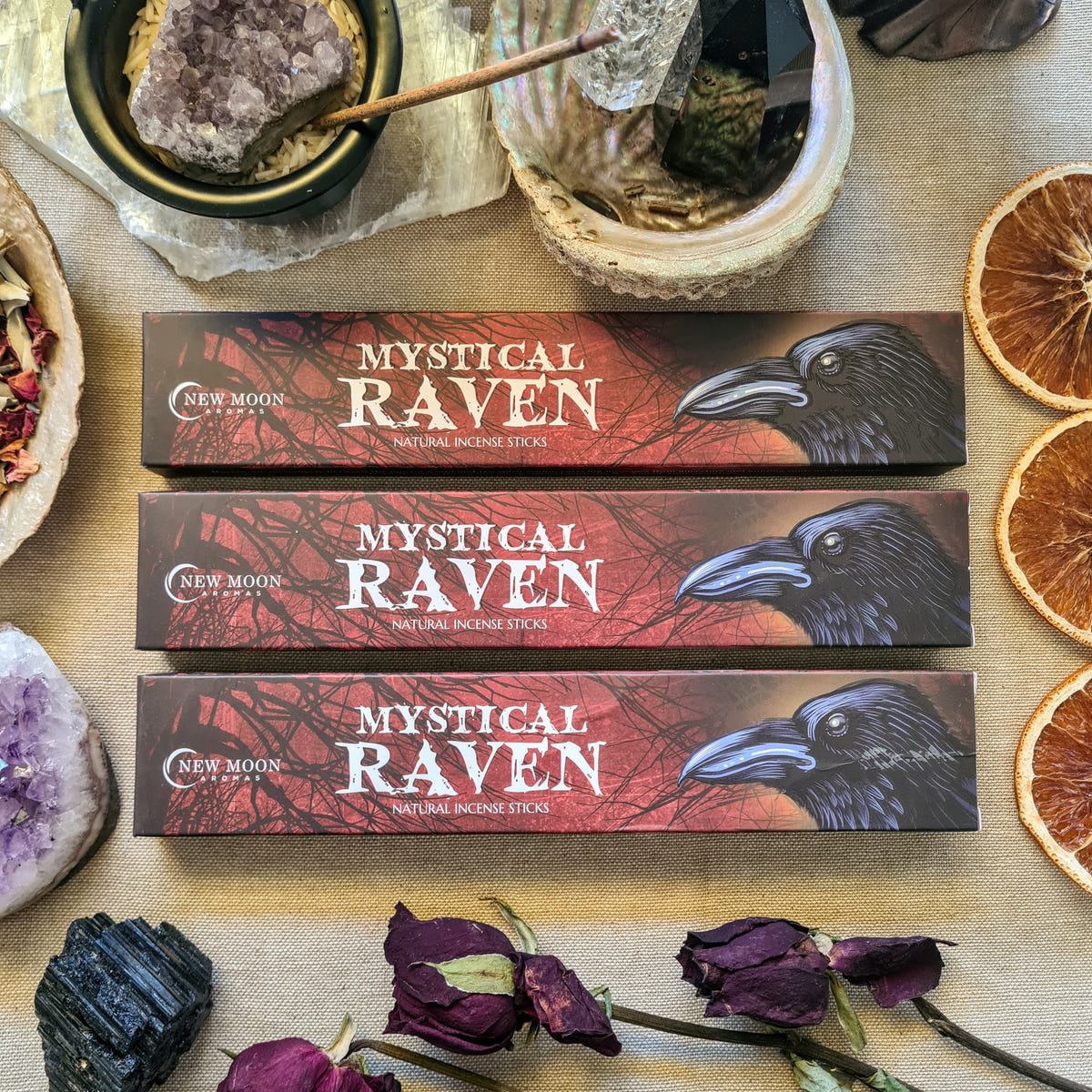 Mystical Raven incense boxes displayed with flowers.