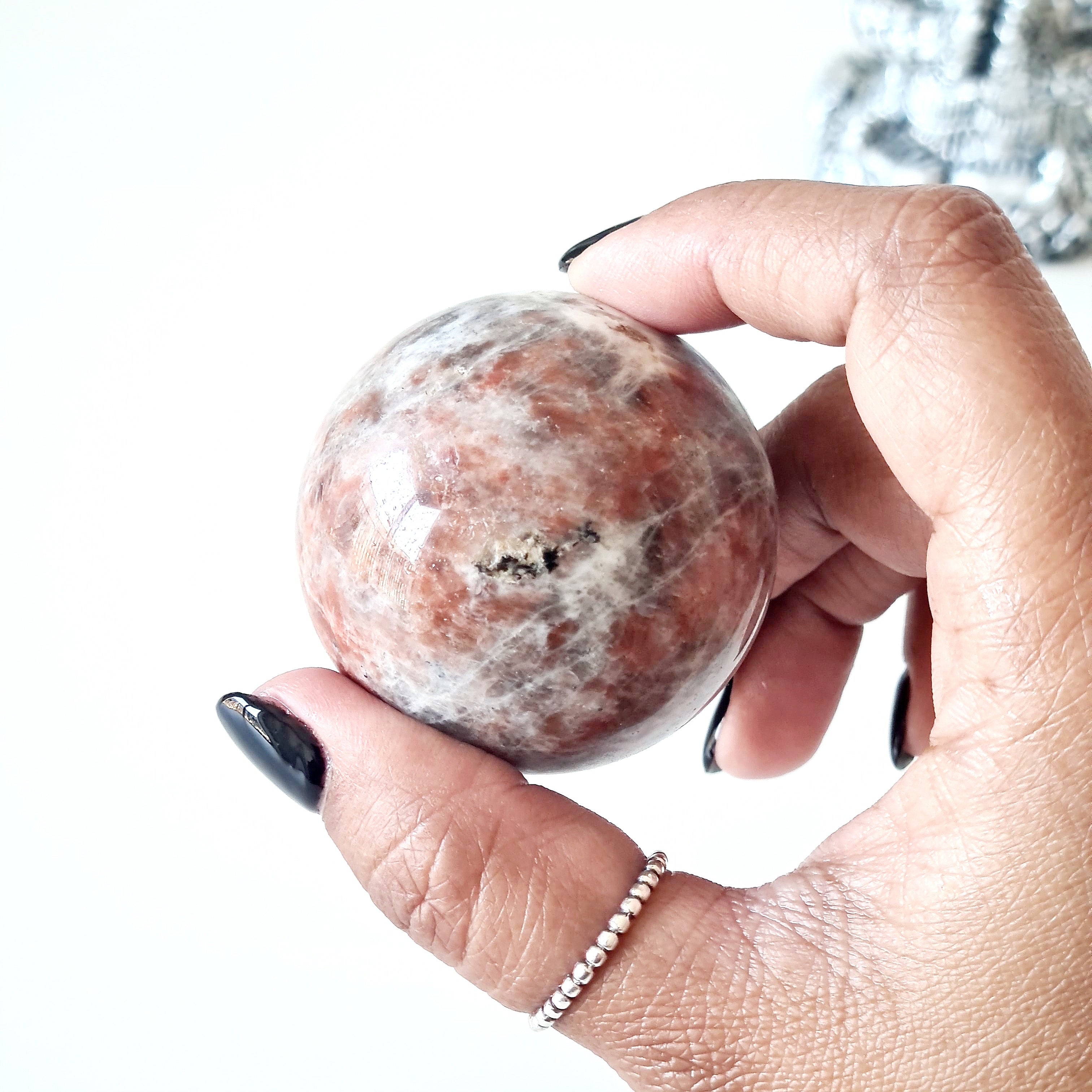 Sunstone peach Moonstone sphere on dragon stand