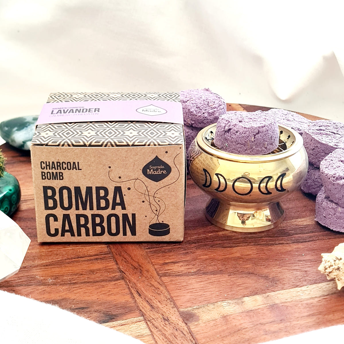 Sagrada Madre Lavender Bomba Carbon box beside purple incense charcoal pieces and a brass burner.