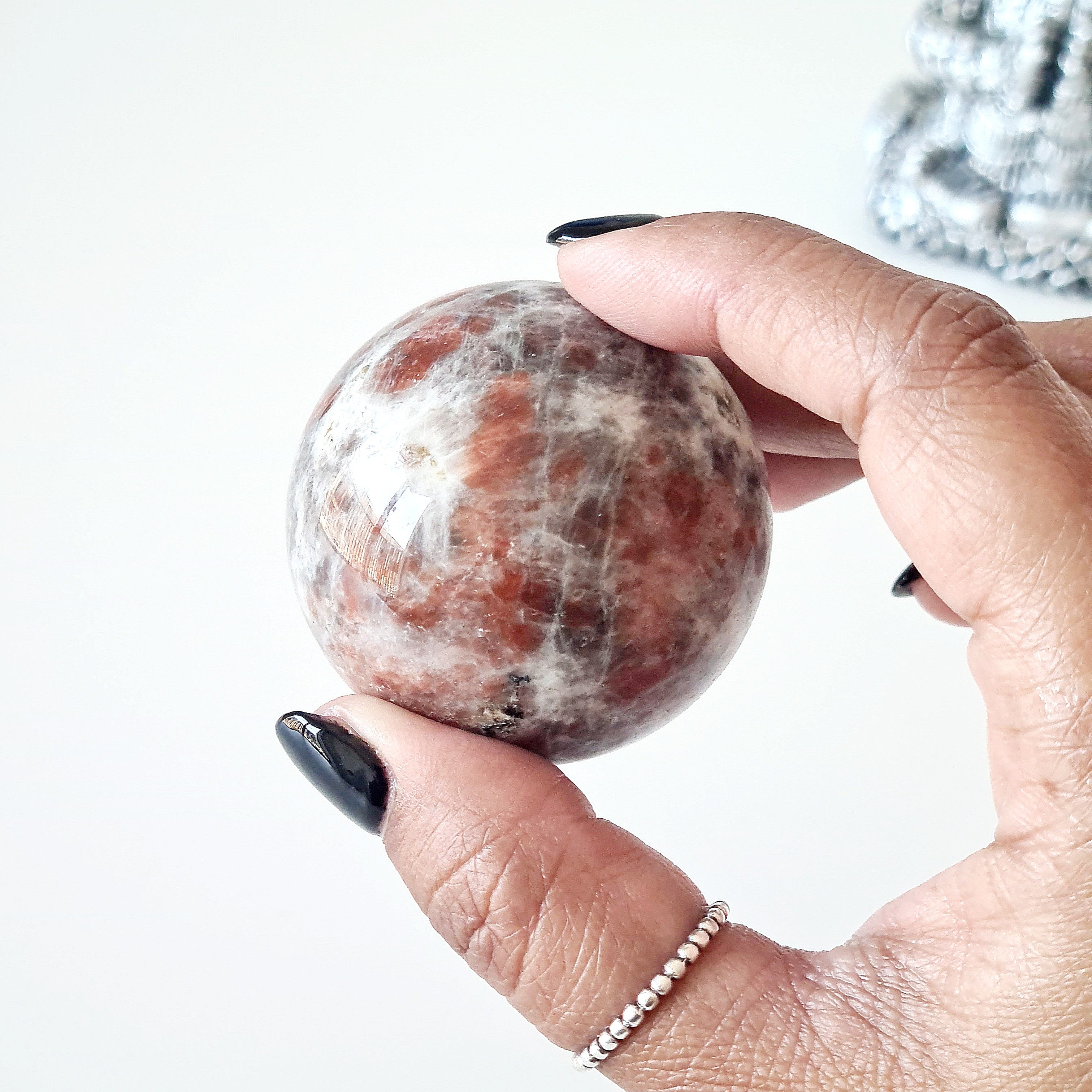 Sunstone peach Moonstone sphere on dragon stand
