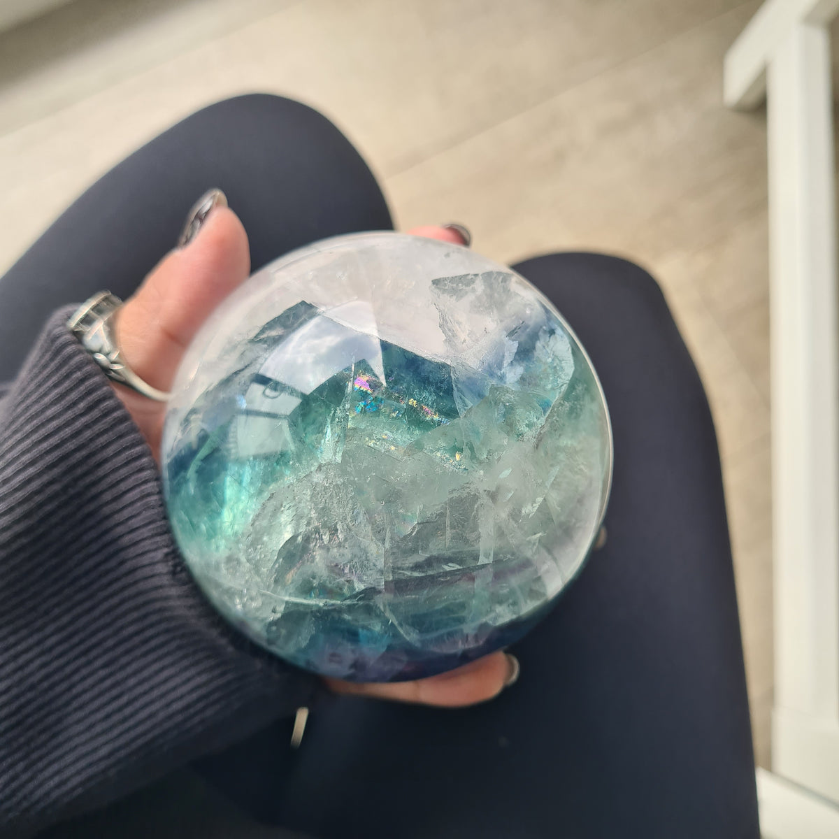 Rainbow Fluorite sphere, 8.5 cm, with green, blue and purple layers and natural internal formations.