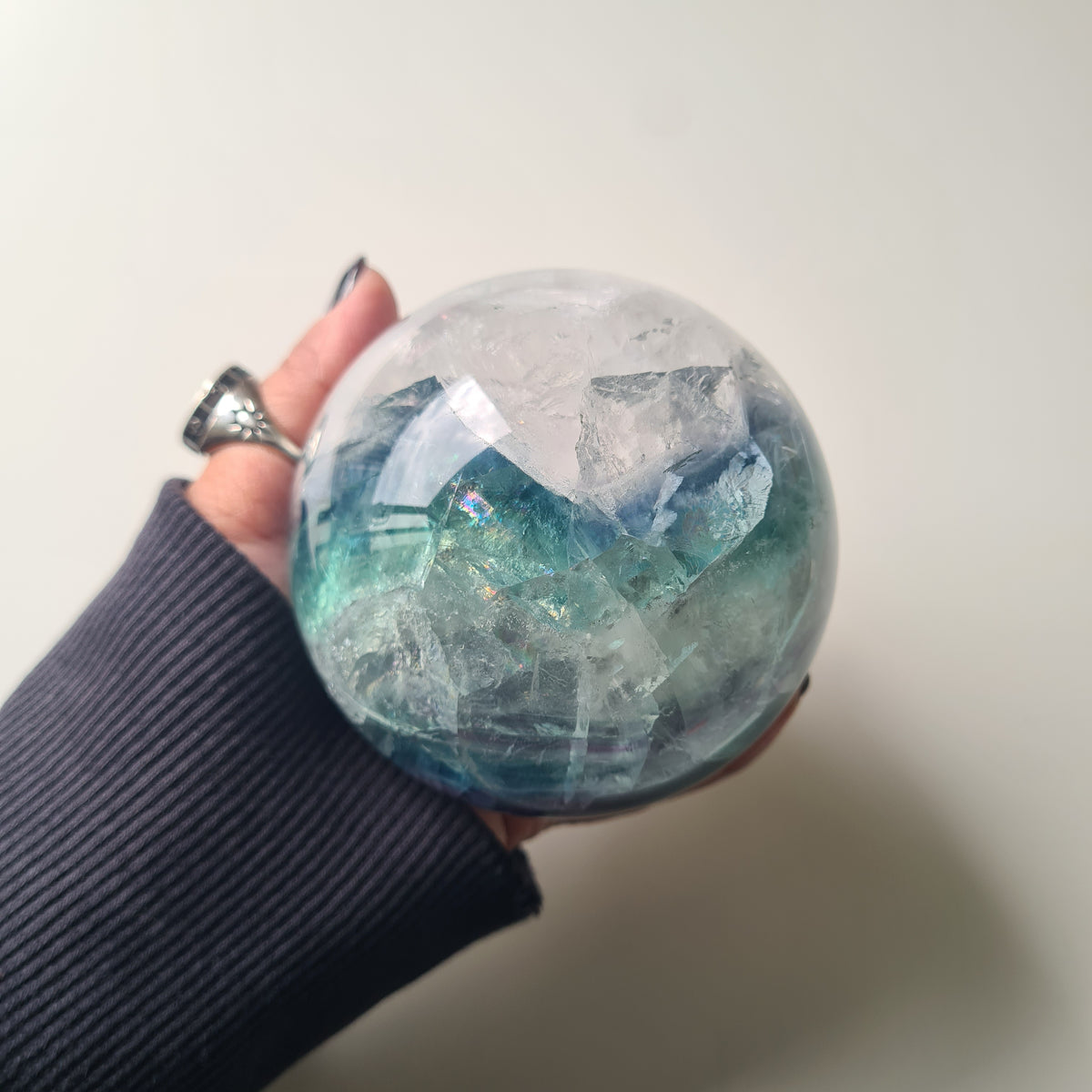 Rainbow Fluorite sphere, 8.5 cm, with green, blue and purple layers and natural internal formations.