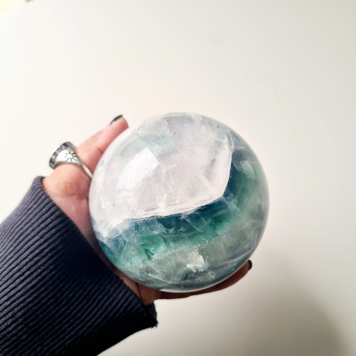 Rainbow Fluorite sphere, 8.5 cm, with green, blue and purple layers and natural internal formations.
