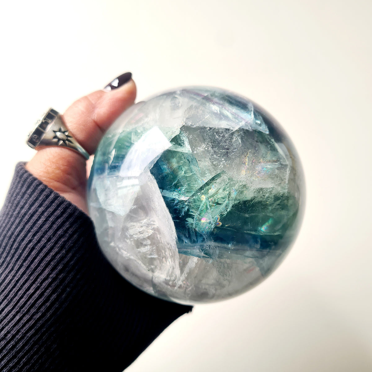 Rainbow Fluorite sphere, 8.5 cm, with green, blue and purple layers and natural internal formations.