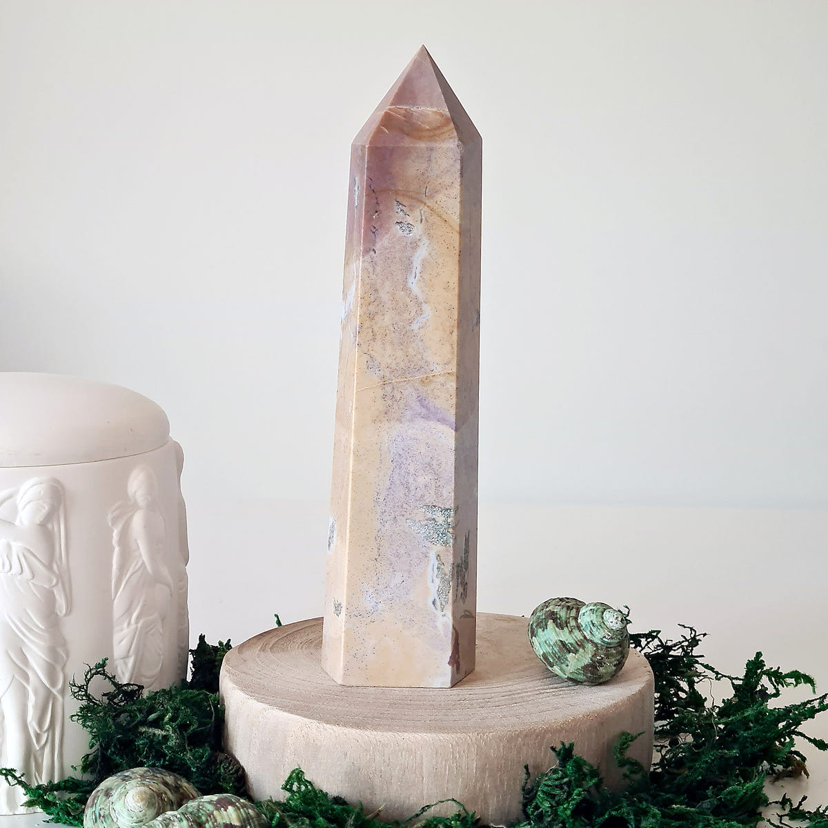 Tall ocean jasper tower 4 with pale pink, cream and lavender vertical sections on a round wooden base.