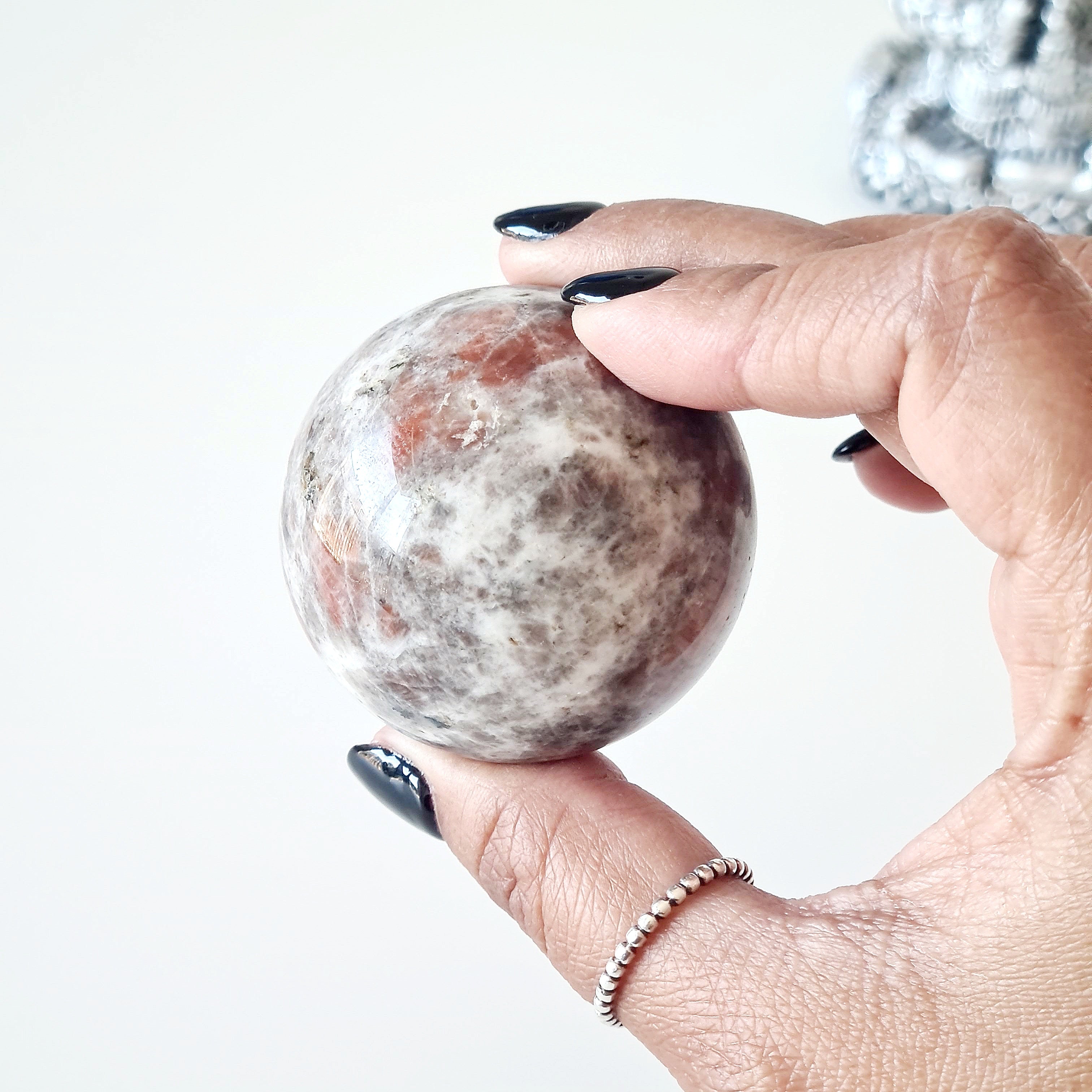 Sunstone peach Moonstone sphere on dragon stand