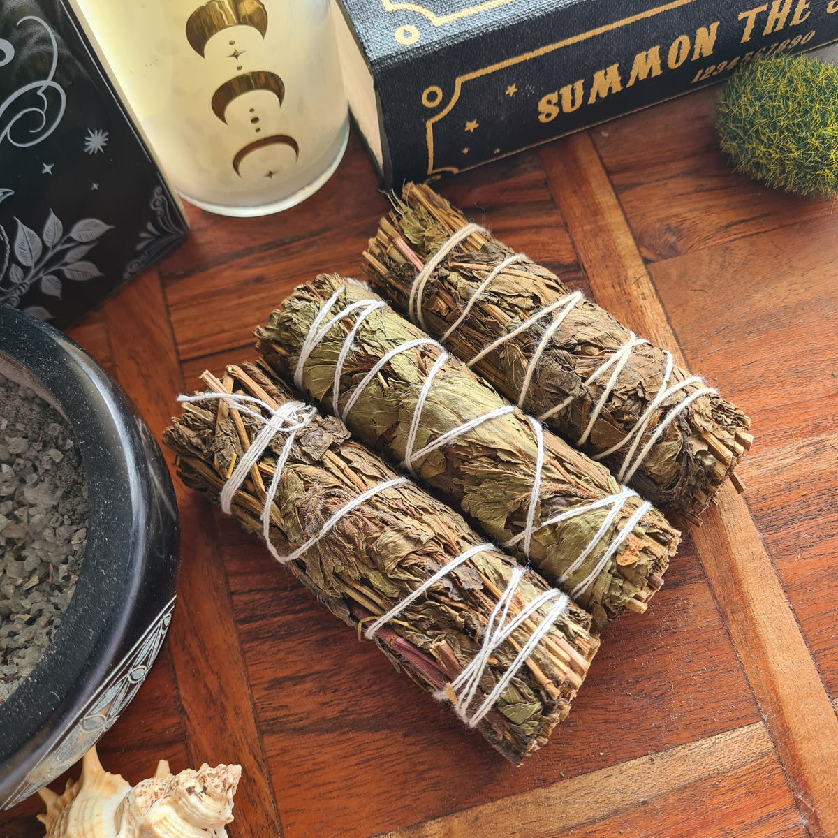 Green and brown Peppermint smudge bundles tied with white string.