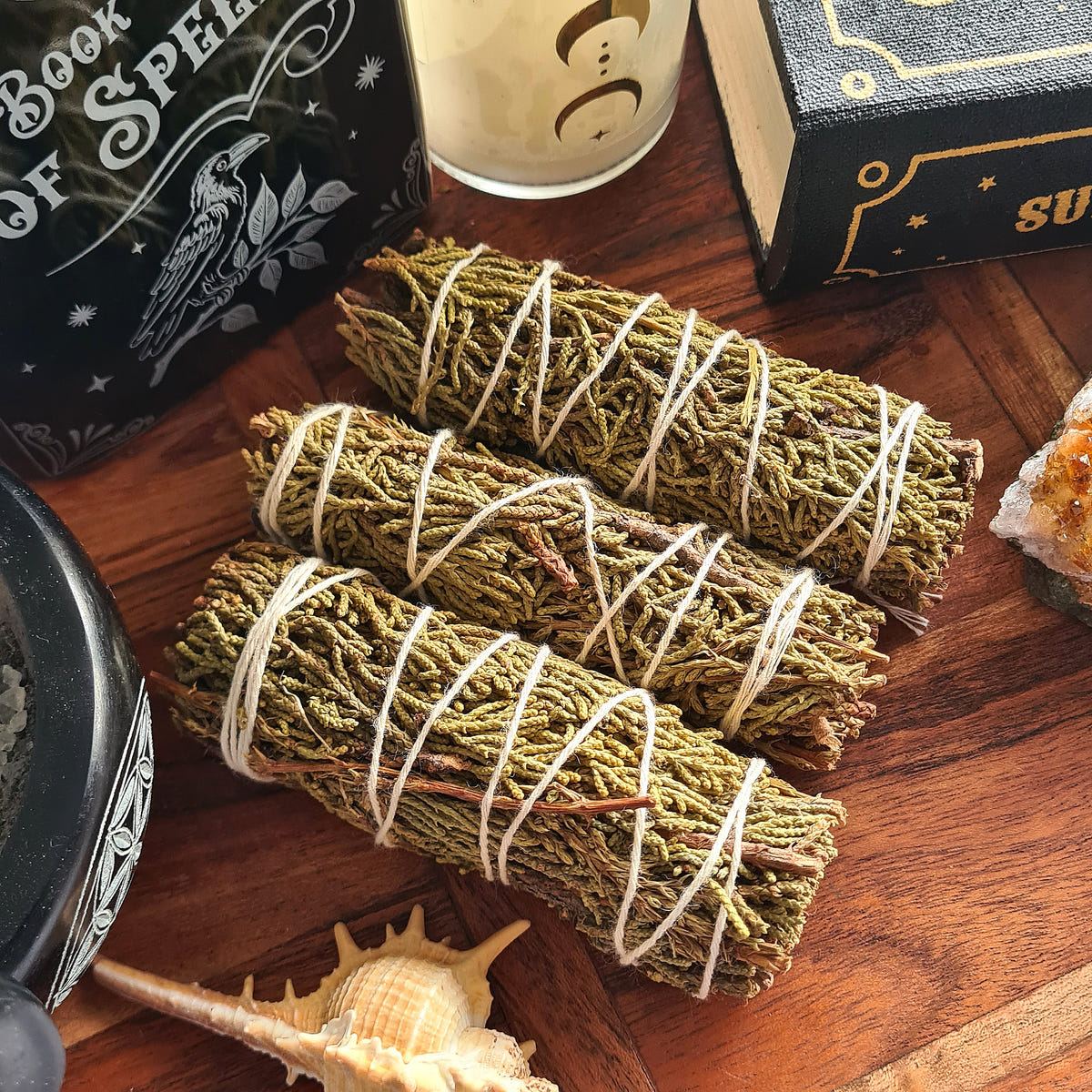 Three Juniper smudge bundles tied with white string.