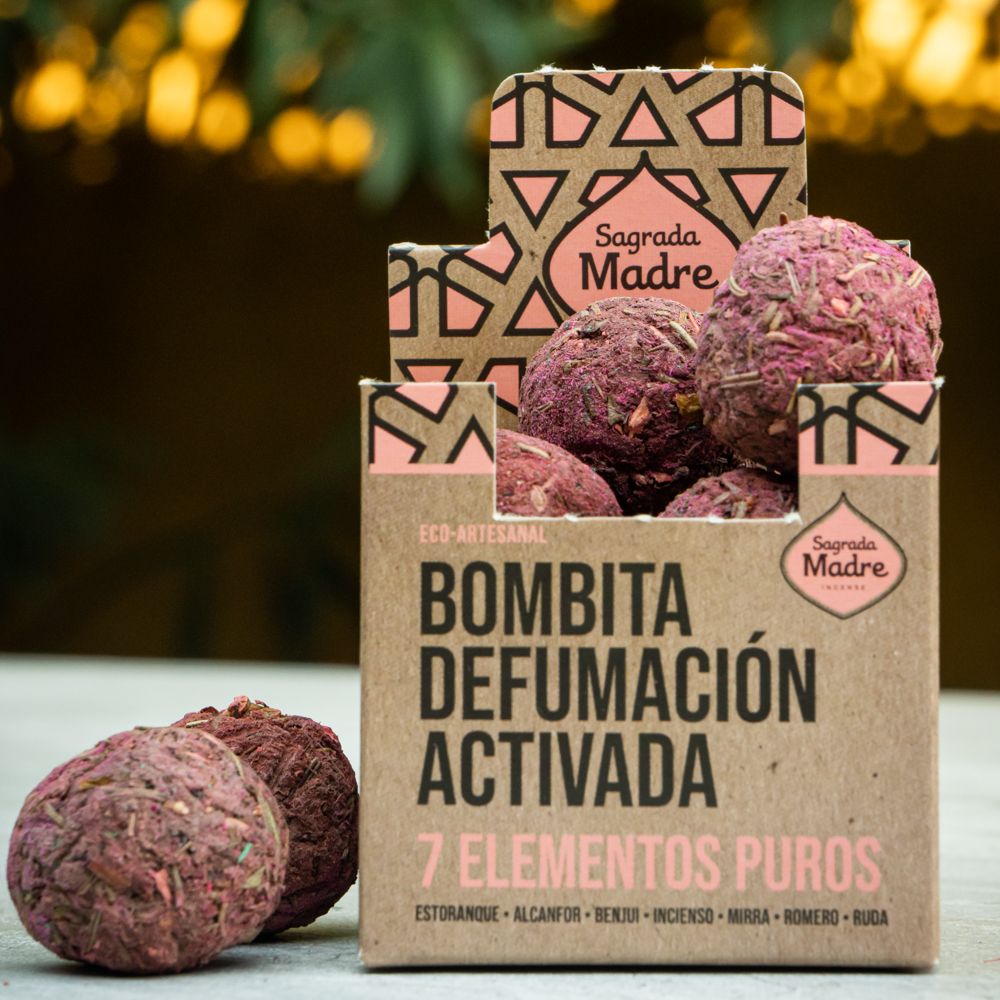 Sagrada Madre 7 Pure Elements smudge bombs in an open pink-labelled box, with herbal incense balls alongside.